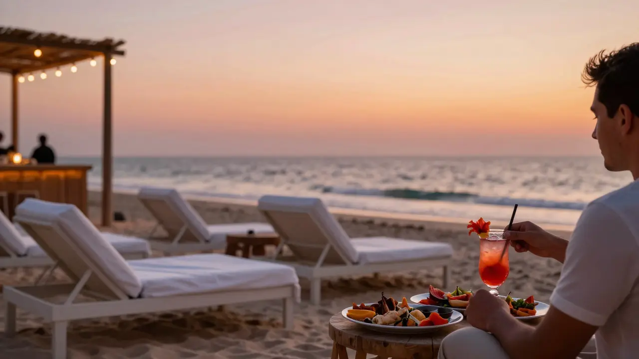 Beachside bar at sunset with loungers and seafood platter under string lights.