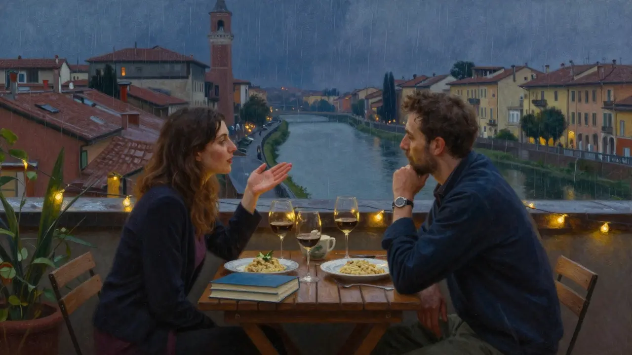 Two people share wine on a rainy rooftop terrace overlooking Milan’s Navigli canals, books and food on the table.